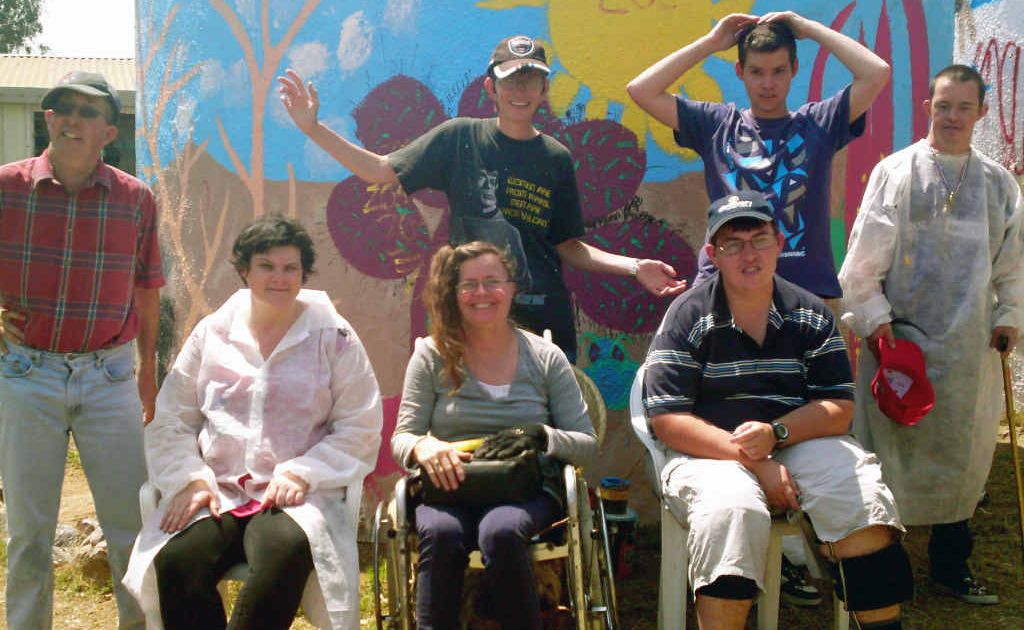 Members of Emerald’s Semita House stand in front of their completed rainwater tank mural. Members of Emerald’s Semita House stand in front of their completed rainwater tank mural.